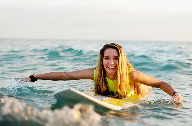 woman riding surfboard