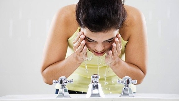 woman-washing-face-getting-ready-after-a-workout