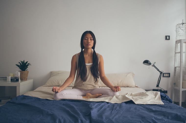 Asian Woman Meditating in the Lotus Position