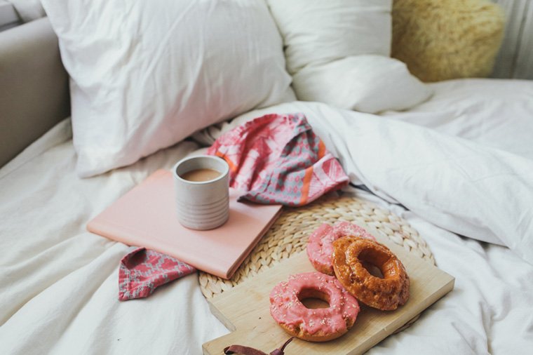 coffee and doughnuts in a bed