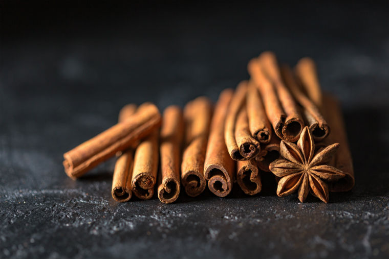 cinnamon sticks laying on black countertop