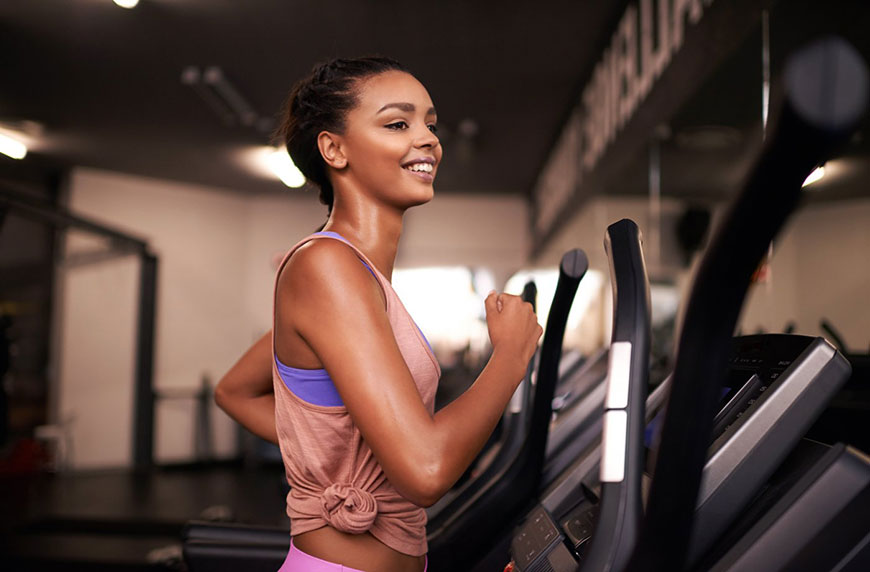 Woman incline treadmill walking at the gym