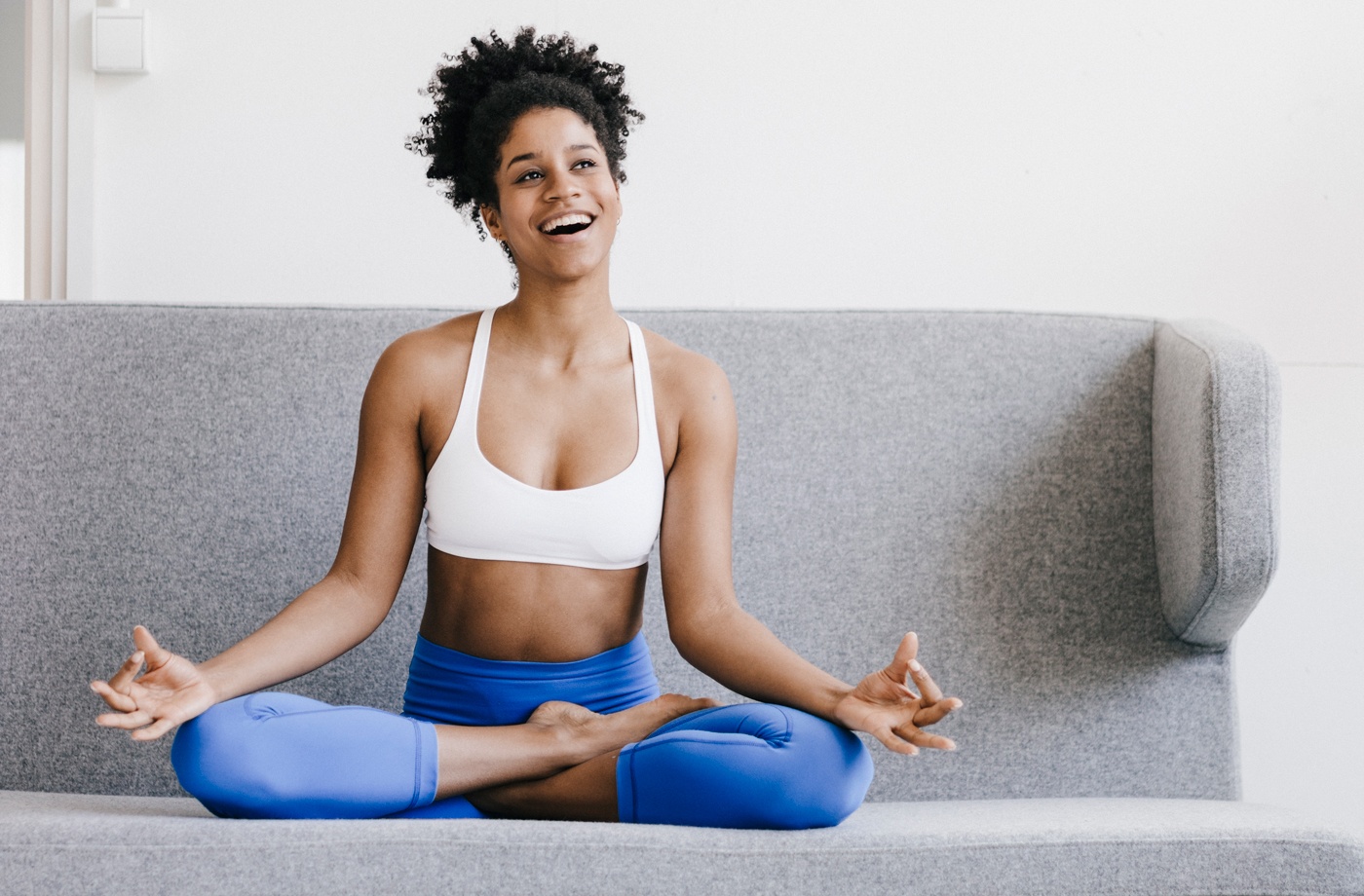 Use your couch for a yoga routine at home | Well+Good