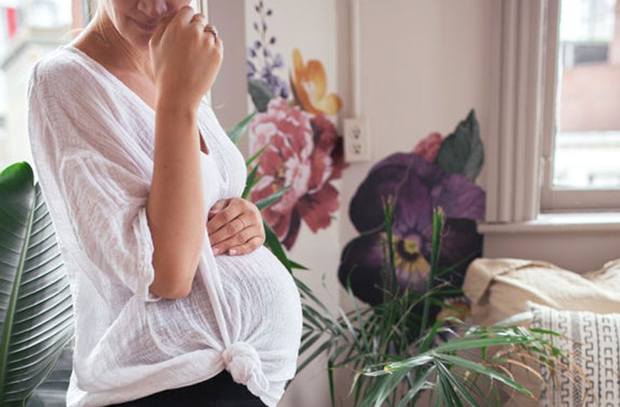 pregnant woman wearing tunic in beautiful room