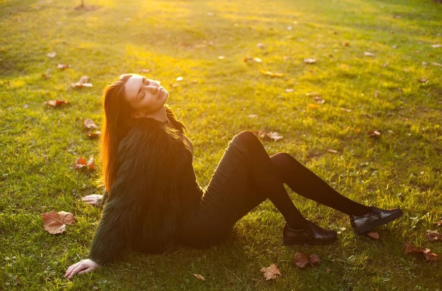 woman sitting in sunlight benefits of sunlight
