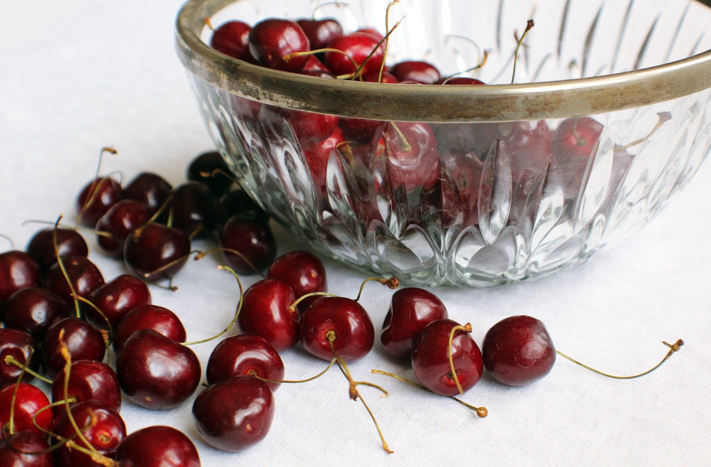 benefits of cherries bowl of cherries on white table