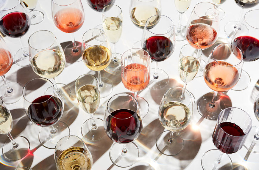 A table loaded with glasses of different kinds of wine to illustrate what causes hangovers.