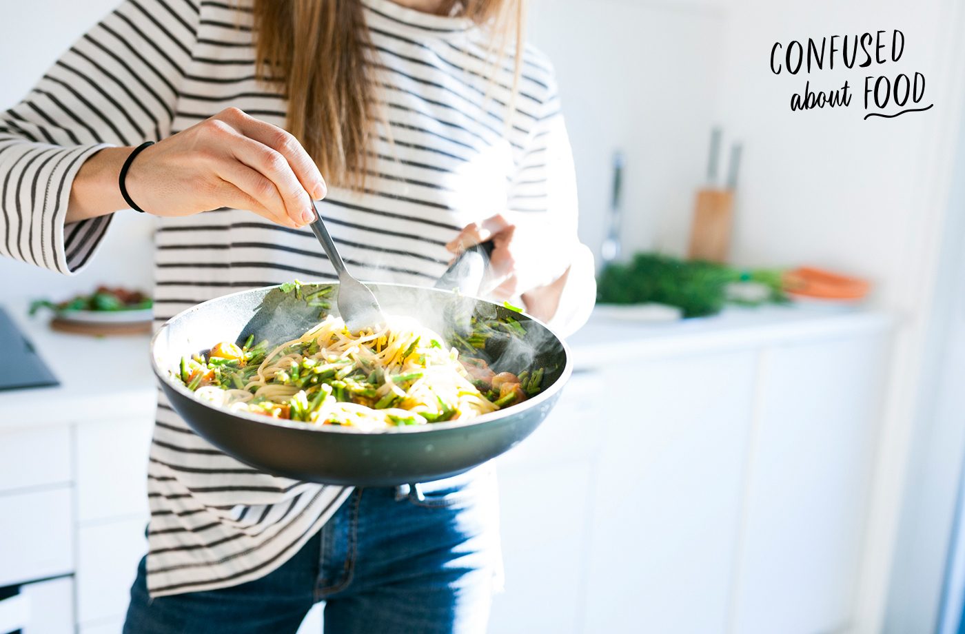 healthy eating advice woman eating pasta out of pan