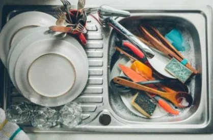 https://www.wellandgood.com/wp-content/uploads/2019/08/Stocksy-kitchen-cleaning-checklist-sink-dirty-dishes-Kkgas-425x285_418x276_true_70.webp