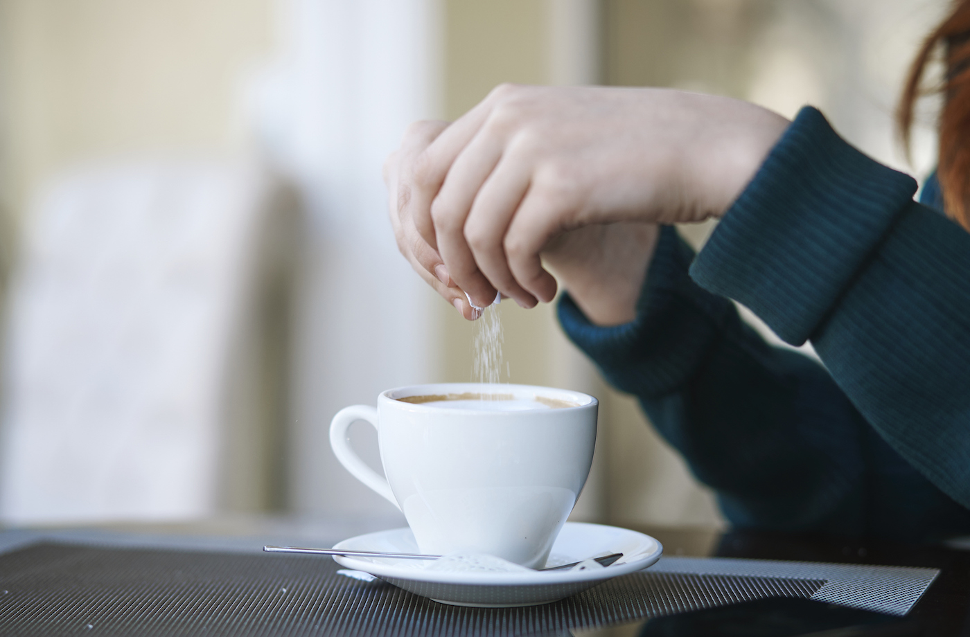 white sugar substitutes woman pouring sugar into coffee