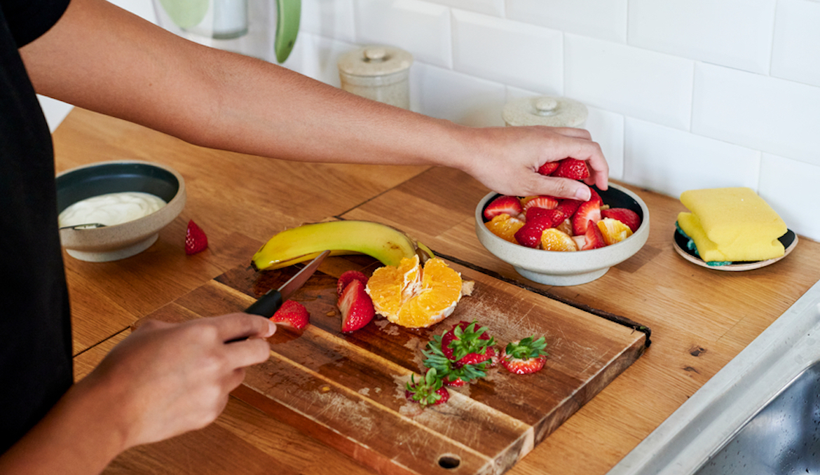 Woman preparing a snack wondering if you can eat too much fruit