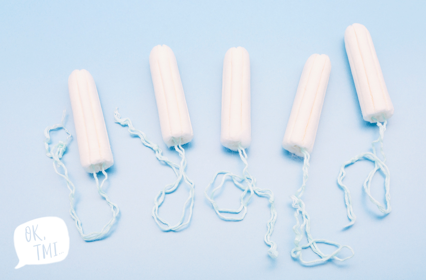 Tampons with blue strings on a blue background.