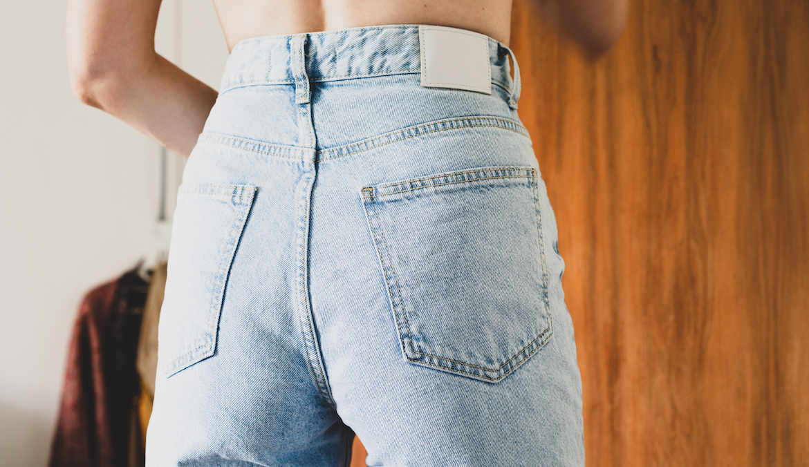 Photo of a woman's butt in high-waisted light wash jeans