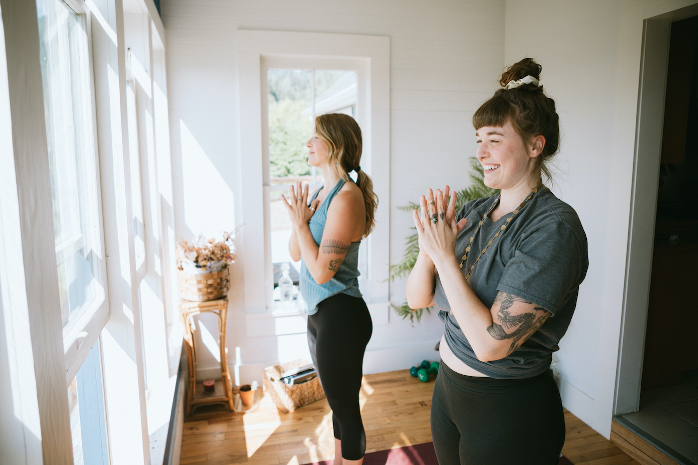 Two women practicing couples yoga poses