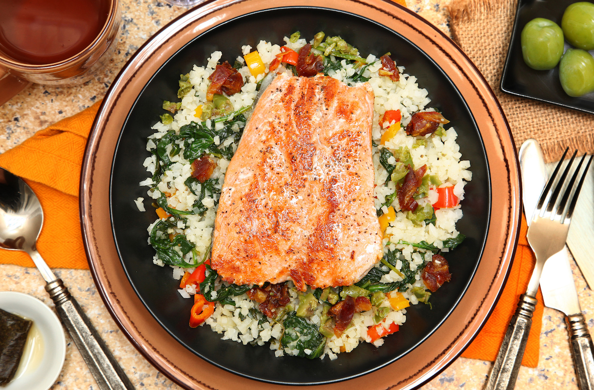 salmon with cauliflower rice and vegetables on plate