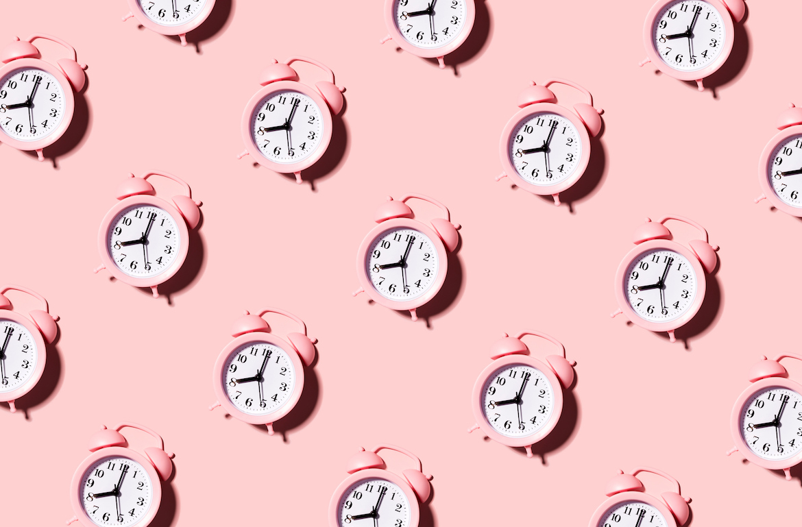 how long does it take to poop alarm clocks on pink background