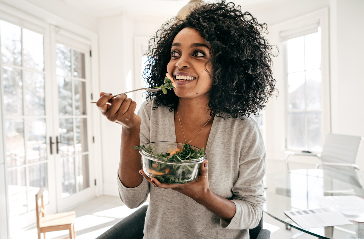 vitamins needed for vegans woman eating green salad