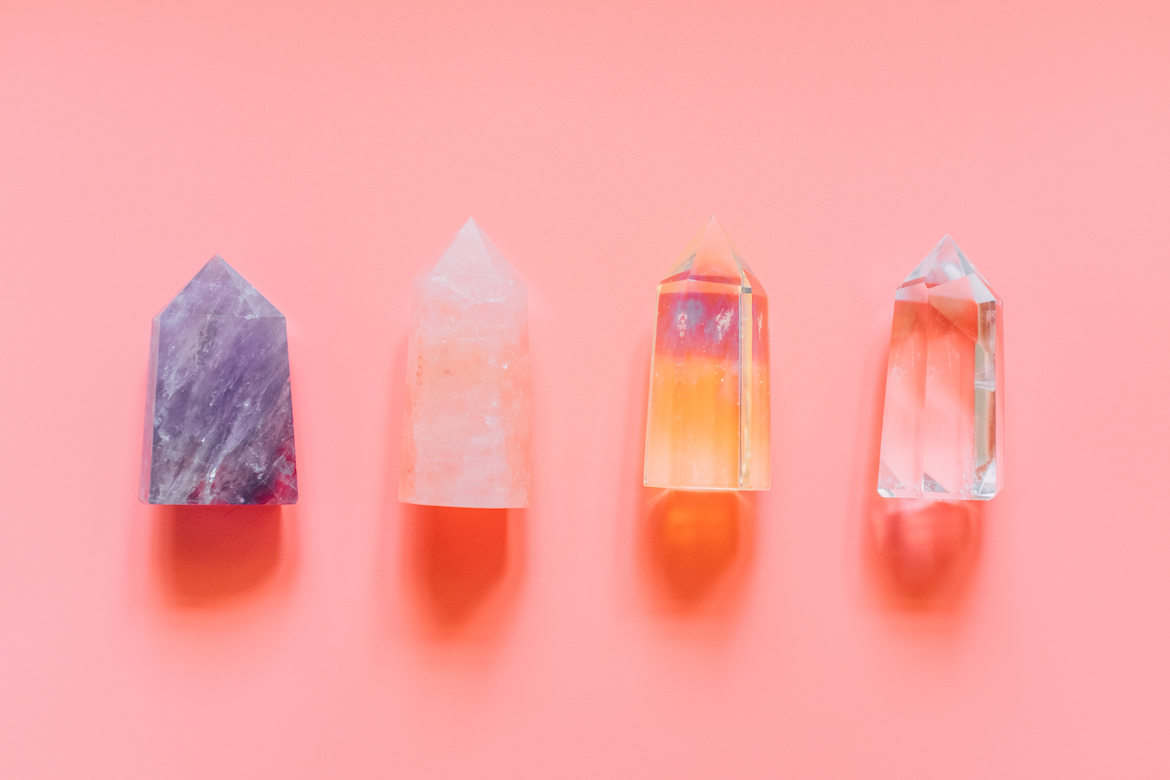 Different types of crystals on a peach background.