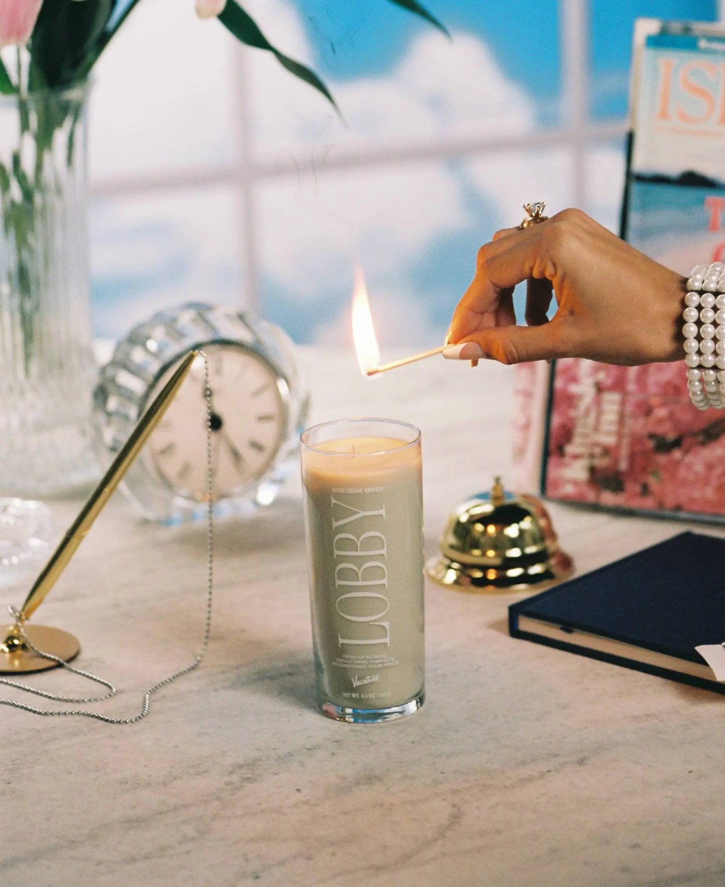 hand lighting the vacation lobby long-lasting candle