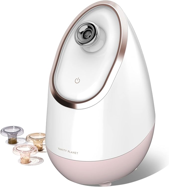 A pink and white vanity planet facial steamer with three aromatherapy attachments