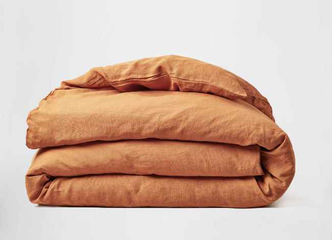 a rust colored silk and snow linen duvet cover with zipper