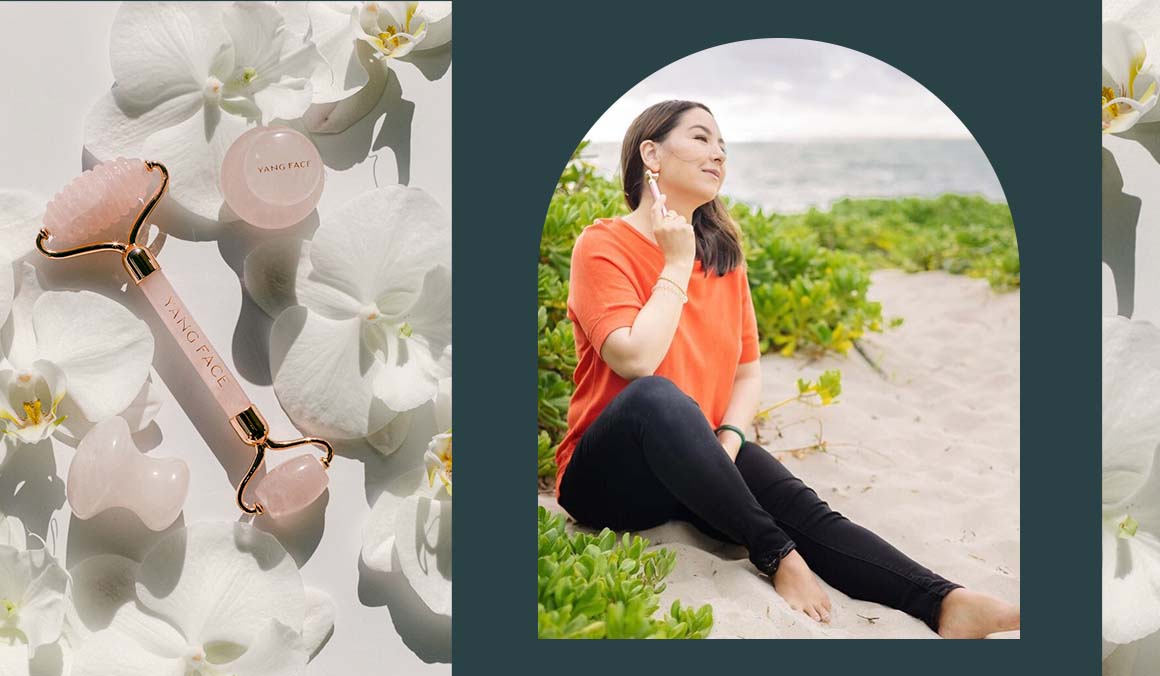 Paige Yang, founder of Yang Face, uses a rose quartz facial roller on the beach.
