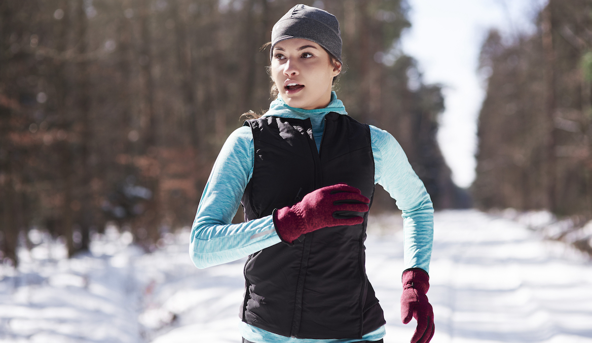 a person running wearing one of the best running gloves for cold weather