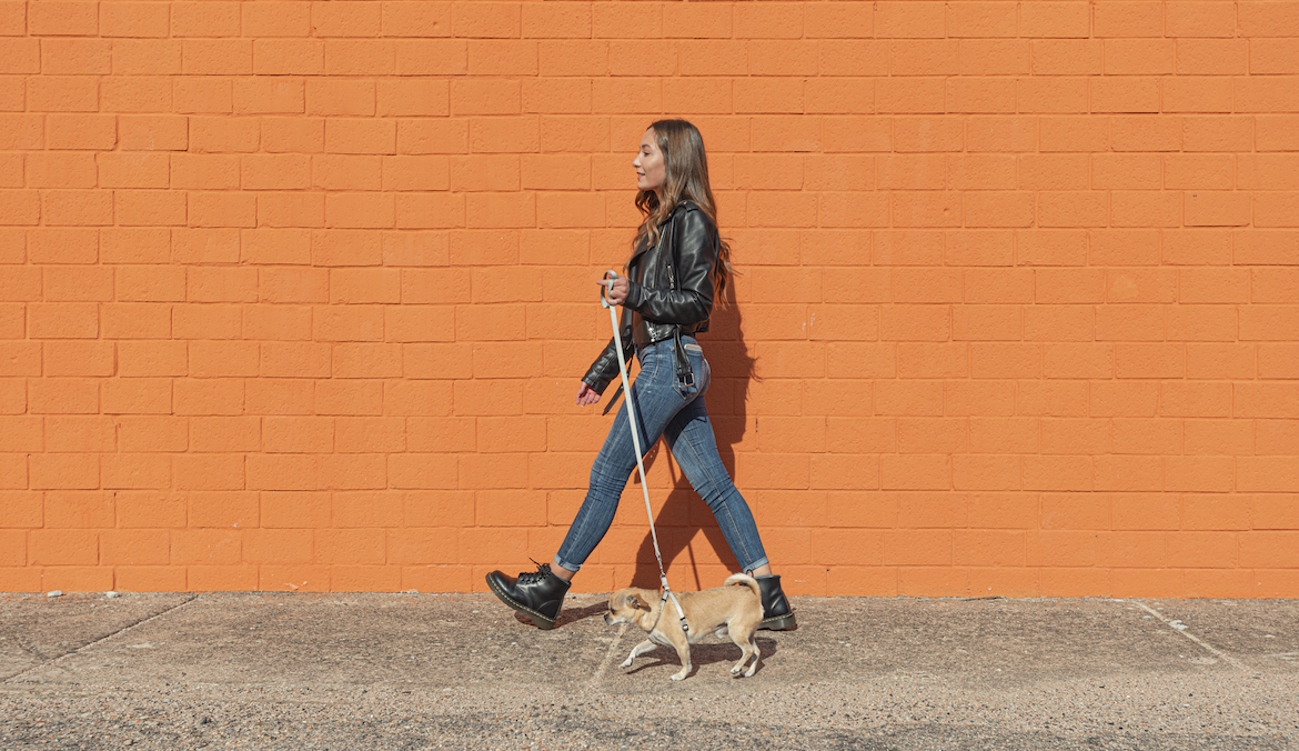 woman walking with her dog, having a good day in march