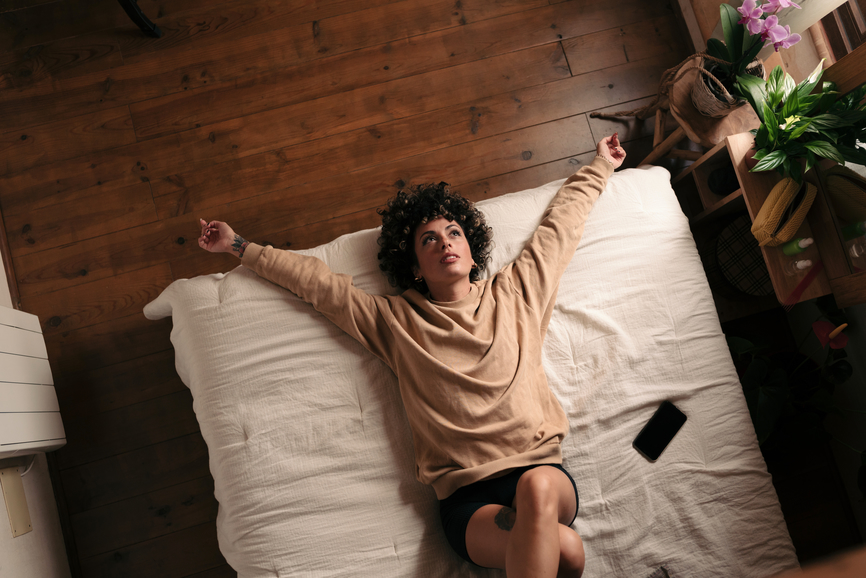 woman lying in bed dealing with toxic relationship