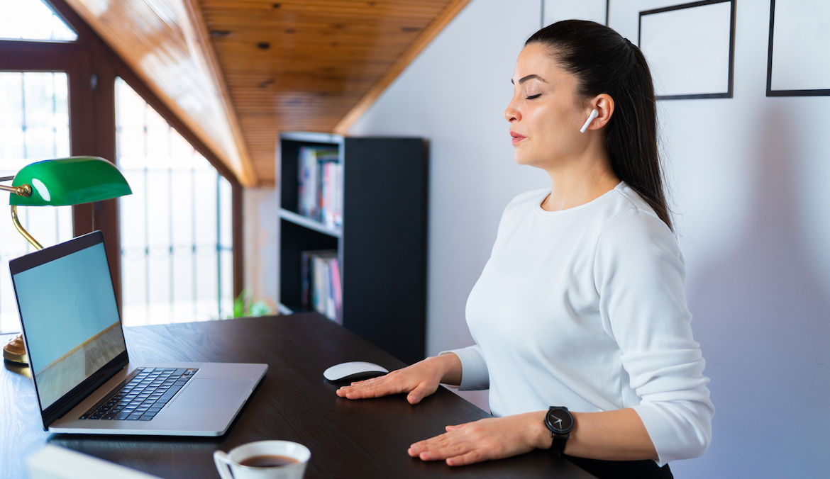 businesswoman deep breathing to manage anger