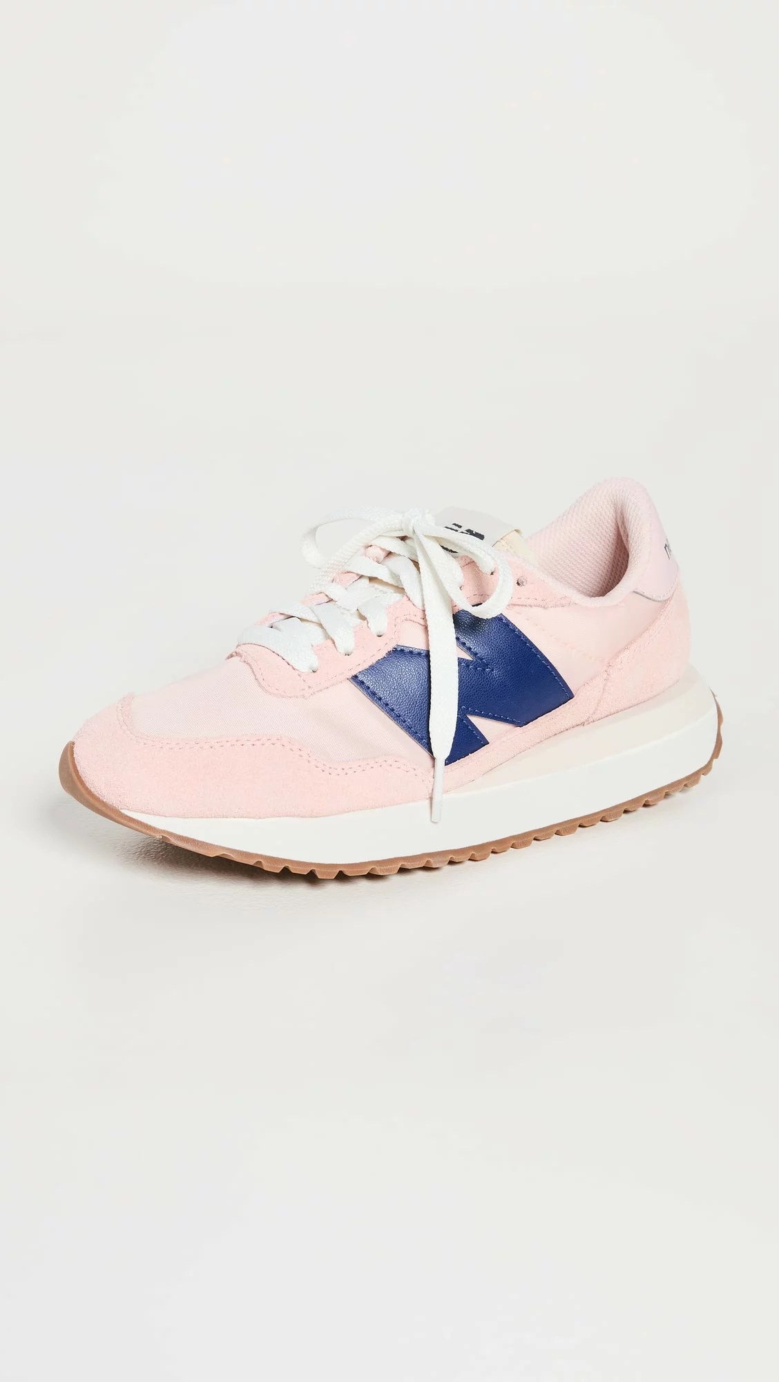 a pink pair of new balance 237 shoes
