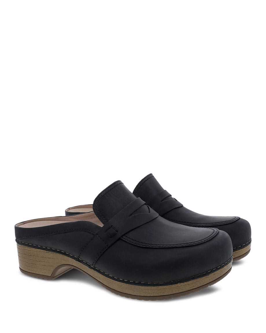 a black pair of dansko bel oiled pull up mules with arch support