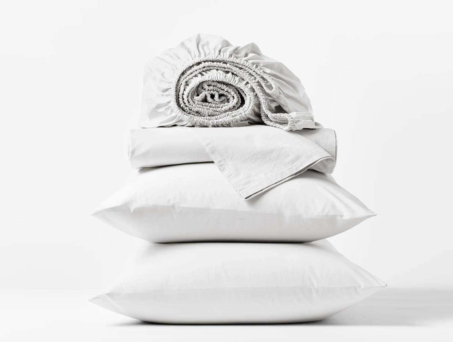 A stack of white coyuchi heritage eco-friendly sheets