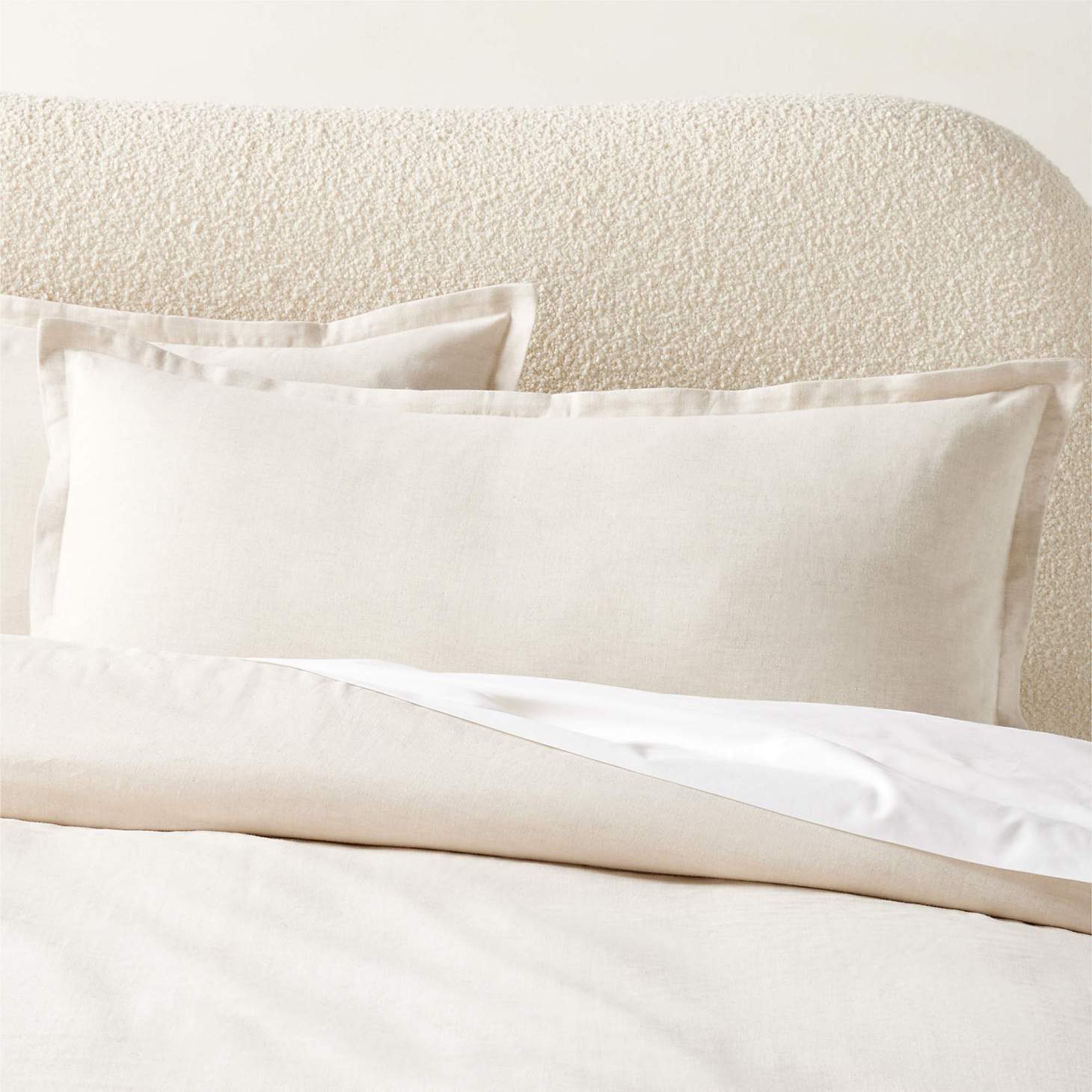 CB2 Kellen pillow shams on a bed