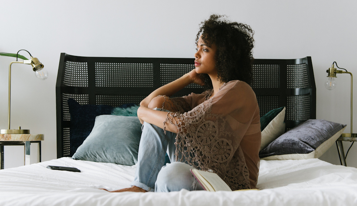 woman on bed contemplating abortion support