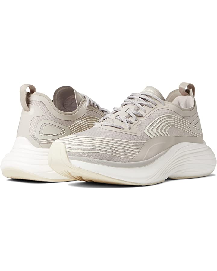a beige APL running shoe with a large, curvy sole.