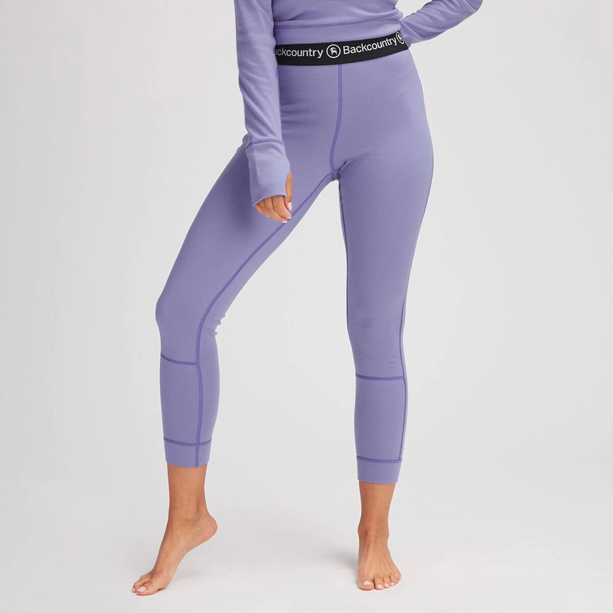 model from the waist down wearing backcountry base layer bottoms in purple that are now on sale at backcountry