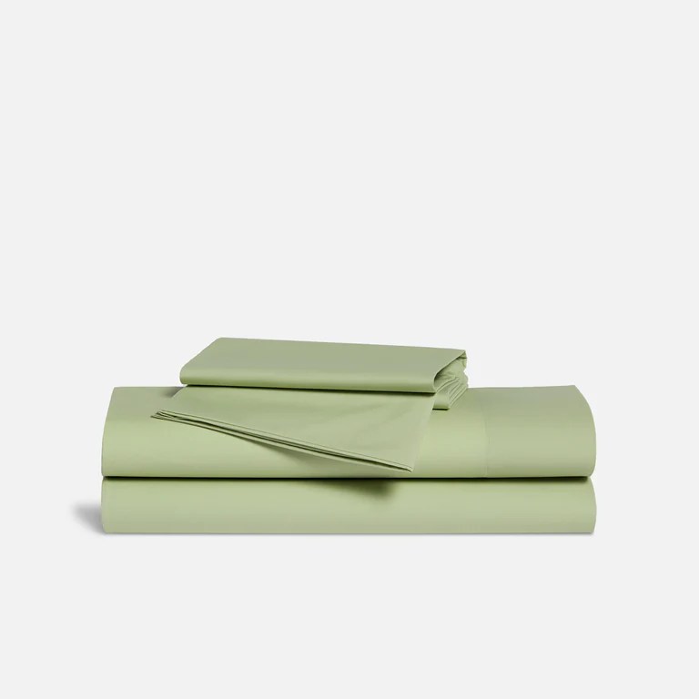 brooklinen classic percale sheets in sage green color on a light gray background
