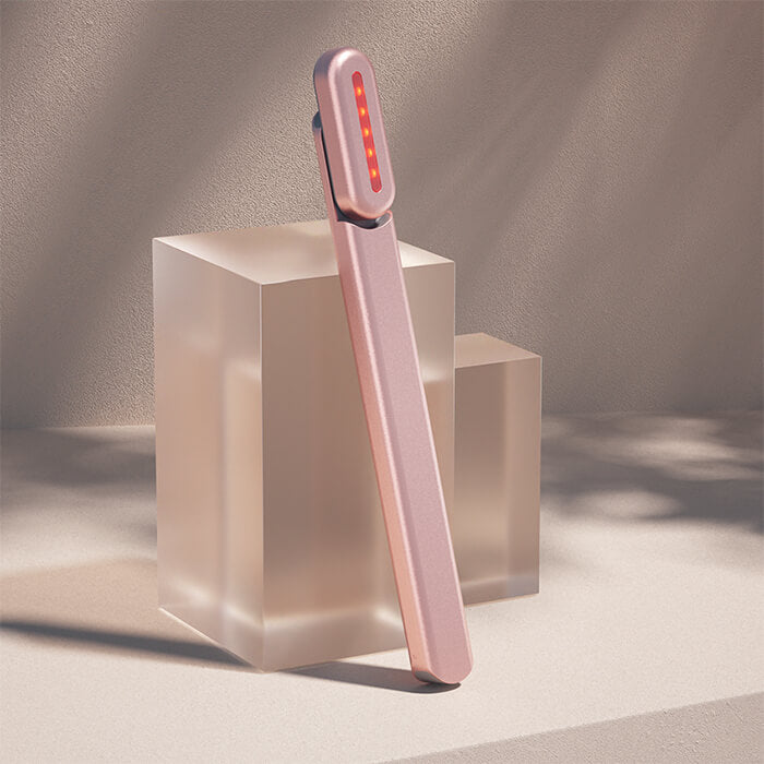 rose gold solawave led wand leaning against a clear cube