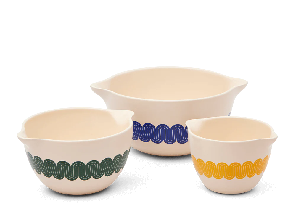 Flip crazy bowls of blue, mustard, and green against a white background