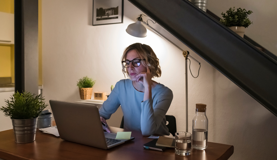 woman working from home on her laptop at night
