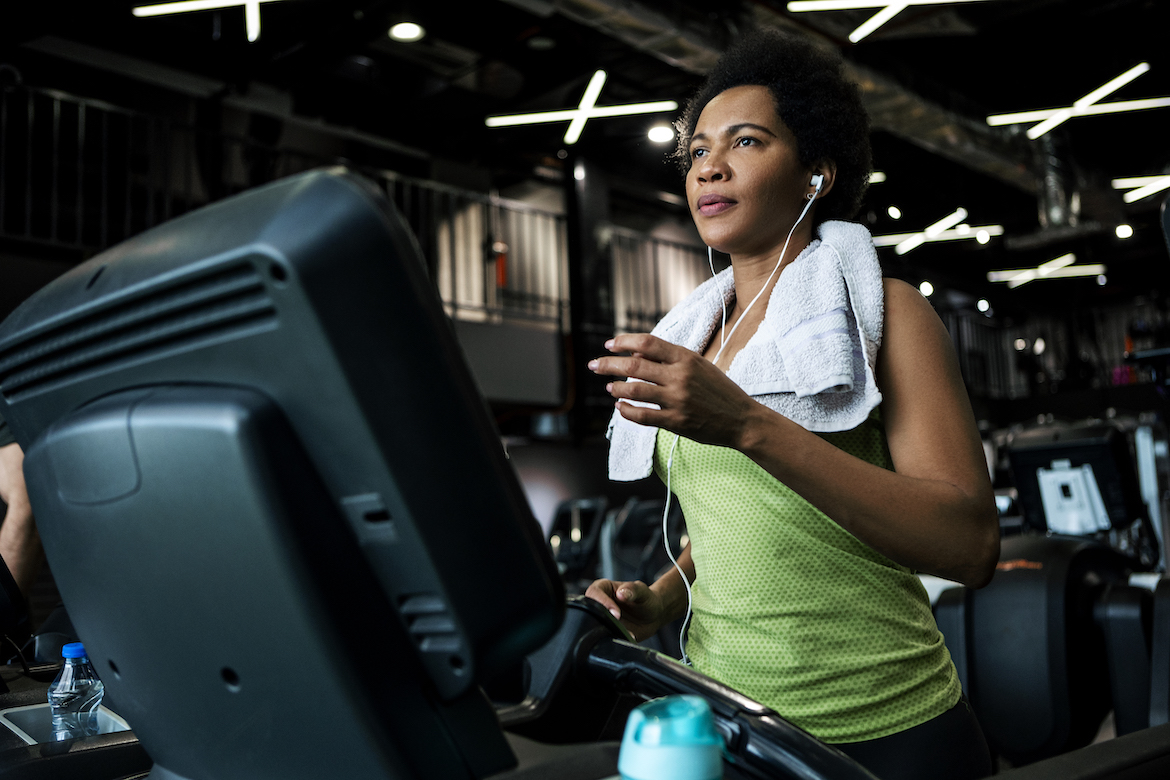 Black woman walking on treadmill