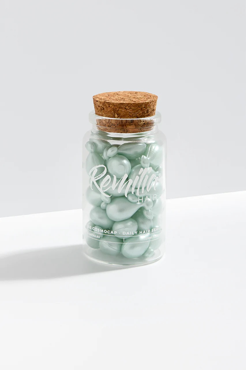 A glass bottle of Remilia hair capsules.
