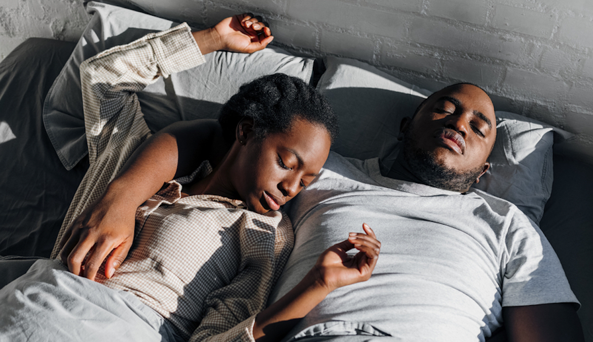 black couple sleeping together in bed