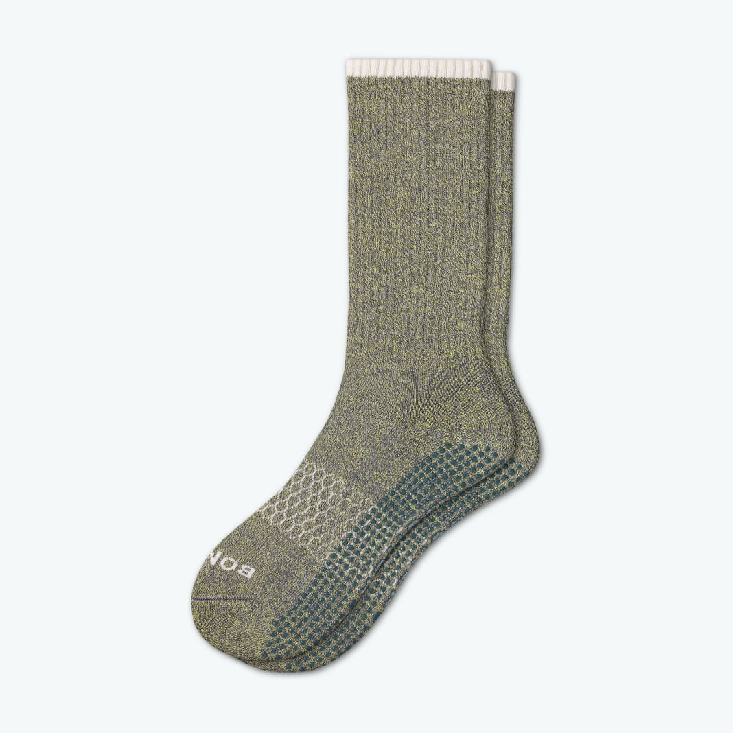 An olive green pair of Bombas grip socks
