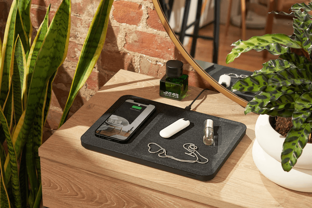 courant catch 3 charging tray on a table with a phone, keys, and necklace on it, best work from home wellness gifts