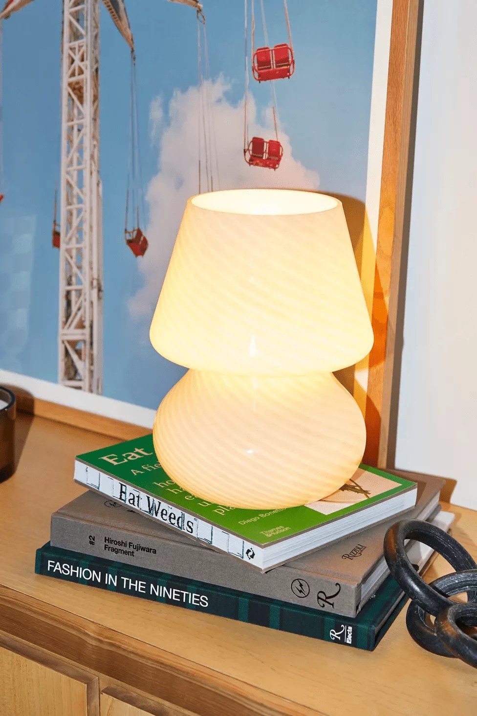 ansel glass table lamp on a stack of books as a work from home gift