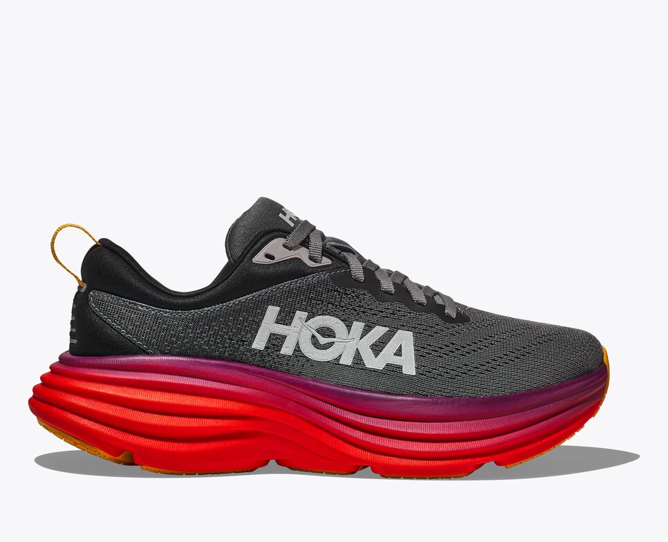 Side view of the black Hoka running shoe with ruby ​​red sole.