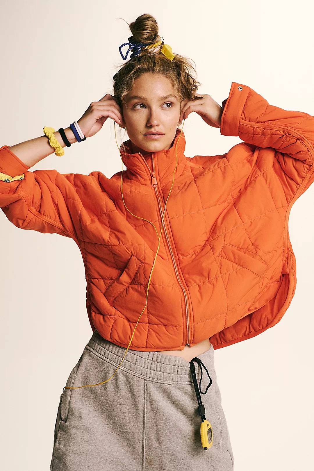 pippa packable puffer in orange on a model