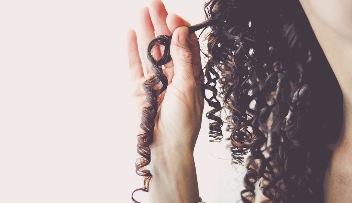 Close-Up of a woman holding her corkscrew curled hair